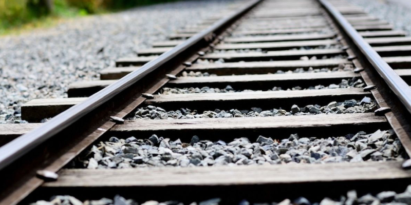 A Close-up View of Empty railroad track - outdoor landscape. Representing Steel Usage In Railway Sector Concept.